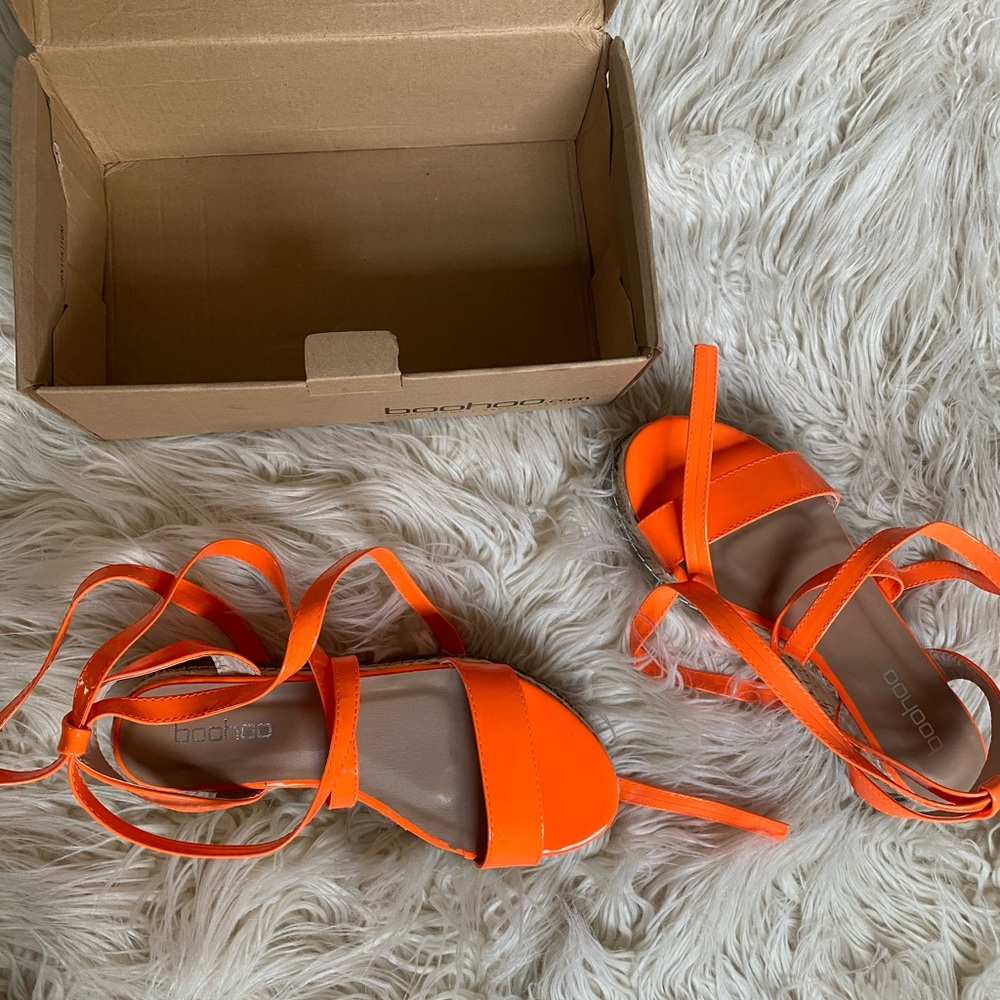 Bright orange patent leather lace up platforms